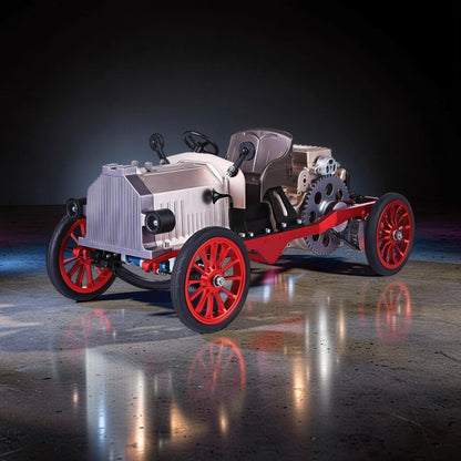 The Curious Mind vintage classic car DIY kit, a metal mechanical model with exposed gears, red wheels, and a silver grille.