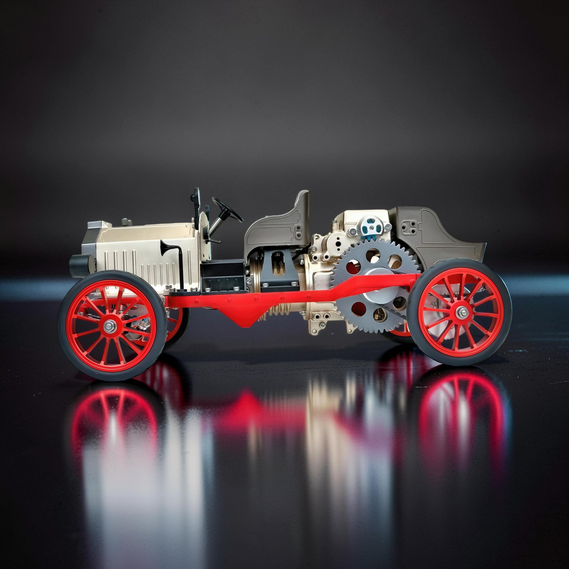 The Curious Mind Vintage Classic Car DIY Kit: metal model with red wheels, exposed engine and gears. Desktop display.