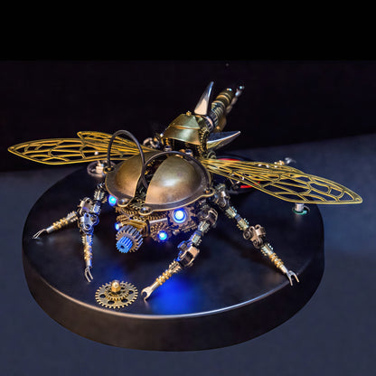 The Curious Mind War Beetle 3D metal model kit with intricate gears, brass body, and illuminated blue lights. Features delicate, golden wings and a steampunk aesthetic.