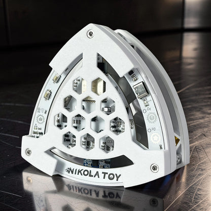 The Curious Mind Self-Balancing Lelo Triangle Kinetic Desk Toy, white ABS, with internal circuitry and LED lights, a modern desk accent.