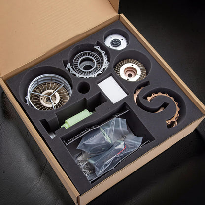 The Curious Mind WS-15 Fighter Turbofan DIY Kit with metal and plastic components neatly organized in a cardboard box with foam inserts.