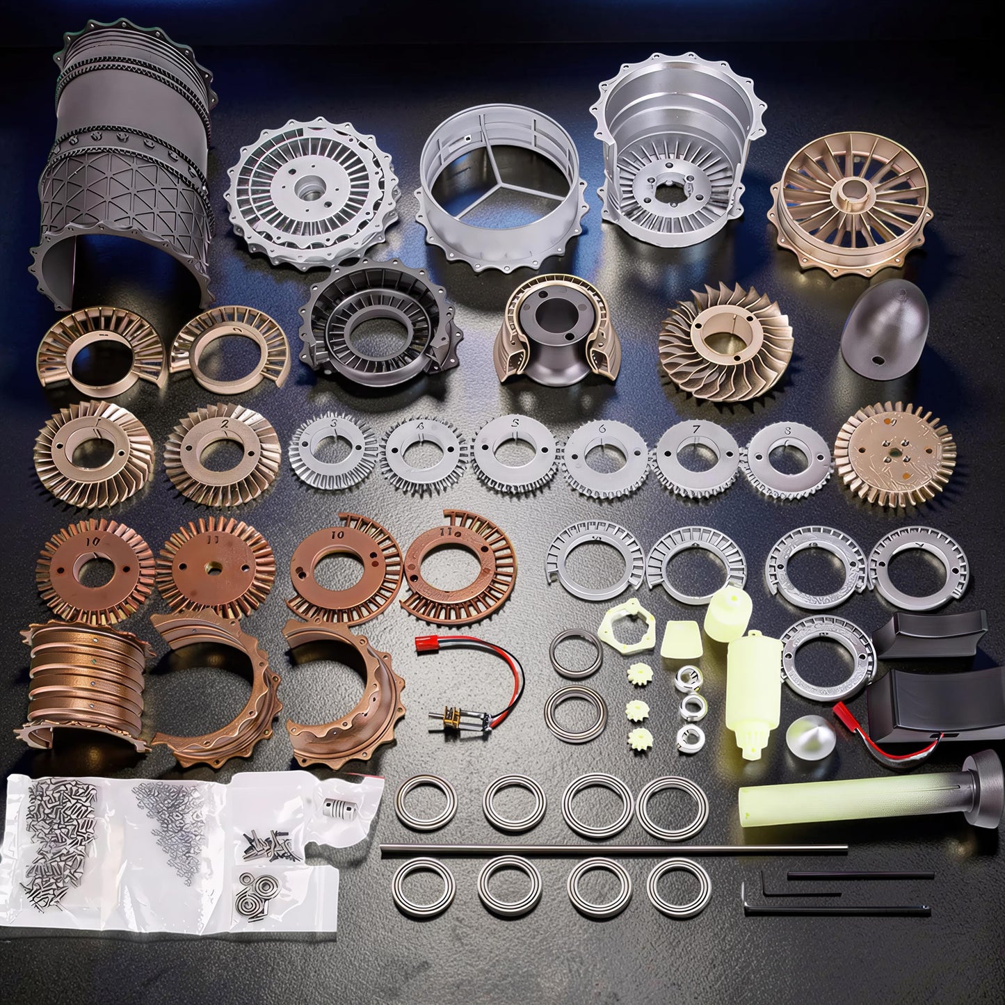 The Curious Mind WS-15 Fighter Turbofan DIY Kit with PLA parts, including fan blades, casings, screws, and assembly tools.