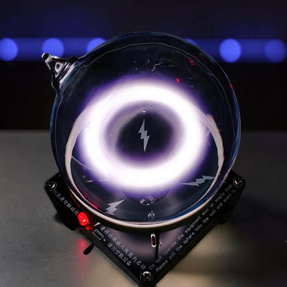The Curious Mind Xenon Ion Ring Glass Sphere displays a glowing purple ring of light inside a glass orb, with lightning bolt graphics. Metal and glass construction.