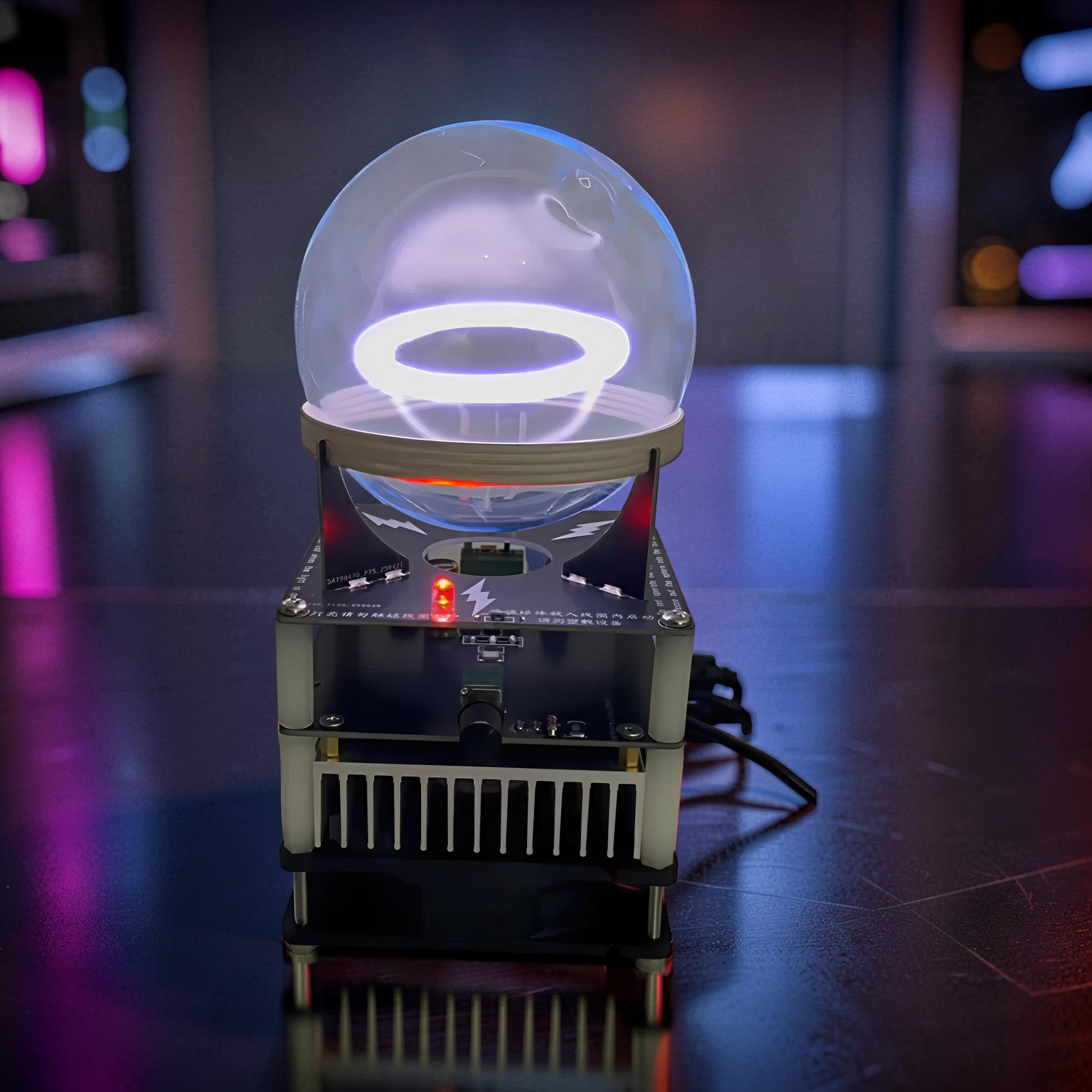 The Curious Mind Xenon Ion Ring Glass Sphere, a science display with a glowing white ring inside a glass orb on a black base with red accents.